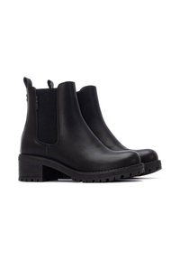 Botas de cuero negras hasta el tobillo con paneles laterales elásticos, punta redonda y un tacón grueso. Presenta una suela texturizada para mayor tracción.