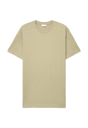 T-shirt beige à manches courtes, col rond texturé, coupe décontractée avec étiquette de marque visible à l'intérieur du col.