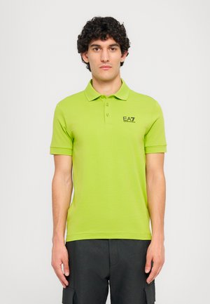 Lime green polo shirt with a three-button placket, short sleeves, and EA7 logo in black on the left chest. Smooth cotton material.