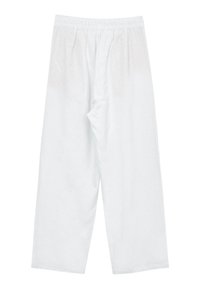 Pantalons larges blancs en tissu léger. Dispose d'une taille élastique et d'un design simple, uni, sans motifs.