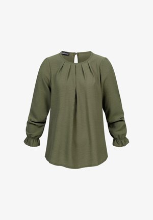Olivgrüne Bluse mit rundem Ausschnitt, gefaltetem Vorderteil und dreiviertellangen Ärmeln, die in rüschierten Bündchen enden. Reißverschlussverschluss auf der Rückseite. Weiches Material.