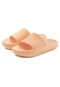 Peach-colored slide sandals with a textured upper, open toe design, and a thick, cushioned sole featuring a ridged pattern for grip.
