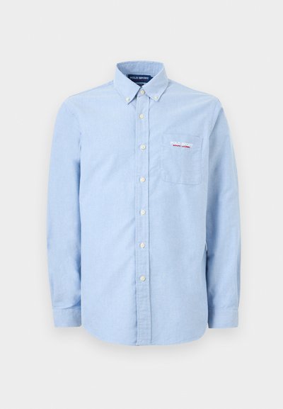 Ανοιχτό μπλε πουκάμισο με μακριά μανίκια και κουμπιά, με γιακά που κουμπώνει, εμπρόσθια τσέπη και κέντημα με το λογότυπο "Polo Sport Ralph Lauren" στην τσέπη.
