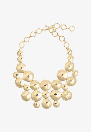 Goudkleurige ketting met meerdere reflecterende, gladde ronde kralen van verschillende maten, verbonden door cirkelvormige schakels en een toggle-sluiting.