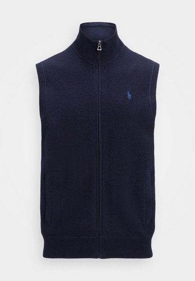 Ναυτικό μπλε αμάνικο γιλέκο με ψηλό γιακά, μπροστινό φερμουάρ και δύο πλάγιες τσέπες. Διαθέτει μικρό κεντητό λογότυπο στα αριστερά.