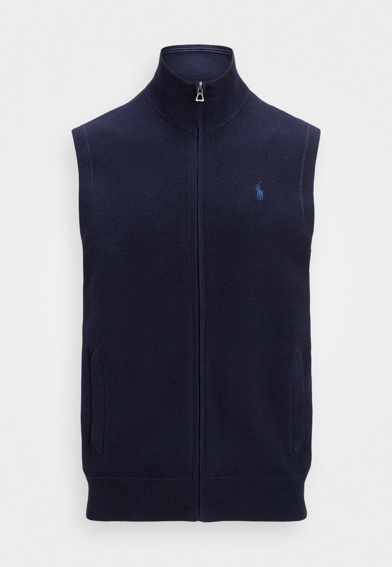 Tamno plava bezrukavna džemper prsluk s visokim ovratnikom, prednjim patentnim zatvaračem i dva bočna džepa. Ima mali izvezeni logo s lijeve strane.