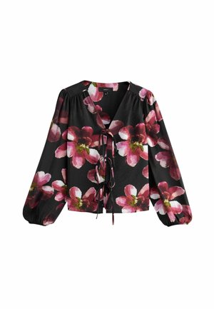 Blusa nera con grandi stampe floreali rosa, scollatura a V, maniche lunghe a sbuffo e chiusura con nodo anteriore. Realizzata in tessuto leggero.