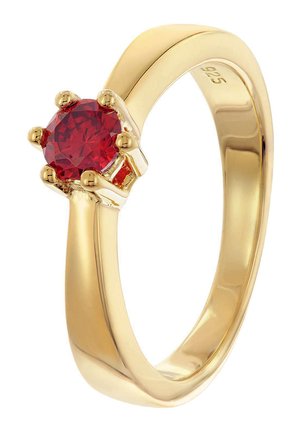 Gold-colored ring featuring a round red gemstone, set in six prongs, with a smooth band and polished finish. Marked "925" for silver content.