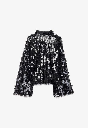 Juodas blizgučių viršus su ilgomis platėjančiomis rankovėmis. Savybės: apvalūs sidabriniai ir juodi blizgučiai, permatomas audinys ir aukšta apykaklė su užsegimu už nugaros.