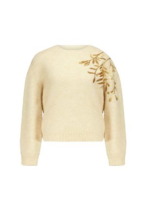 Crème-kleurige trui van zacht materiaal, met lange, opgeblazen mouwen en ingewikkelde gouden borduursels van takken aan de linkerkant.