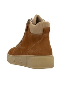 Brown suede mid-top sneaker with ribbed collar, side zipper, and rubber sole. Features distinctive stitching and rounded toe design.