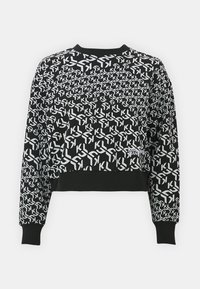 Sudadera negra corta con un patrón geométrico blanco de "KL" en toda la superficie y puños, escote y dobladillo acanalados. Pequeño logo de "Karl Lagerfeld Jeans" en el frontal.