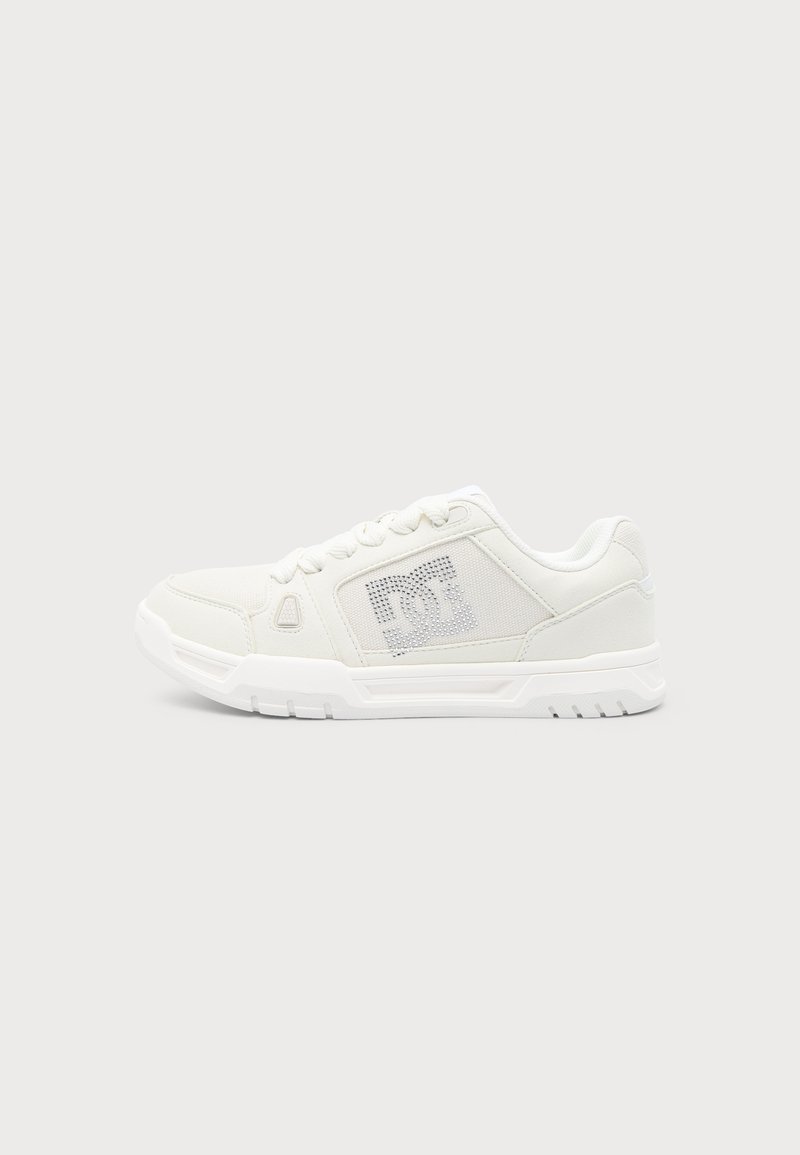Λευκό χαμηλό sneaker με κλείσιμο με κορδόνια, υφασμένο πλαϊνό πάνελ με διάτρητο λογότυπο DC και παχιά καουτσούκ σόλα.