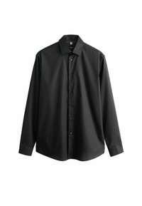 Chemise noire à manches longues boutonnée, avec col pointu et poignets boutonnés, présentée sur fond blanc.