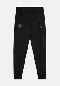 Pantalones deportivos negros hechos de tela ligera. Presentan el logotipo naranja del Paris Saint-Germain y el emblema rosa de Jordan en el muslo izquierdo. Cintura elástica.