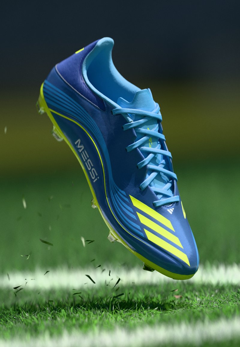 Blue and yellow soccer cleat with a glossy finish, featuring a streamlined design, laces, distinct stripes, and transparent studs.