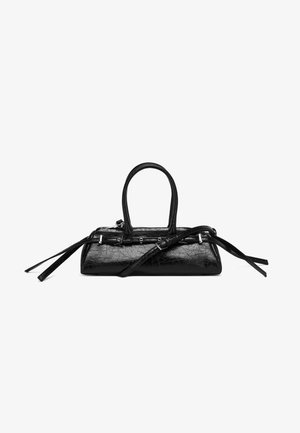 Glossy black leather handbag with structured shape, two handles, and a long adjustable strap laid across the base on a white background.
