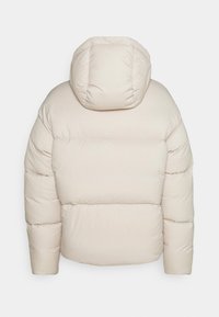 Padded puffer jacket in light beige with a hood. Features quilted sections, straight hem, and full sleeves. Smooth, soft texture.