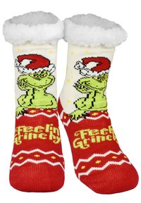Un paio di calze natalizie rosse e bianche con il Grinch verde che indossa un cappello da Babbo Natale e la scritta "Feeling Grinchy" in giallo.