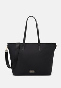 Black tote bag with a smooth nylon exterior, featuring long leather straps, a detachable shoulder strap, and a gold logo plaque.