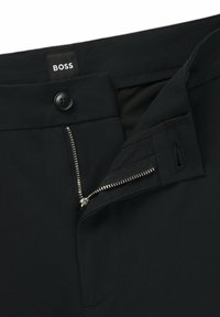 Black trousers featuring a button closure, a zippered fly with silver hardware, and a smooth, solid fabric texture. Brand label "BOSS" visible.