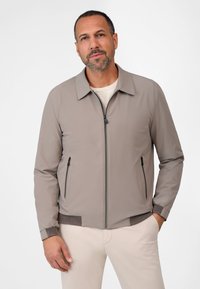 Light grey bomber jacket with a zip front, two side zip pockets, ribbed cuffs, and a textured hem. Smooth texture and sleek design.