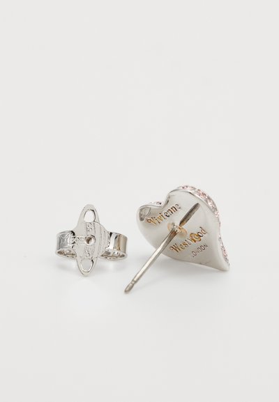 Silver heart-shaped earring with pink accents and engraved text, paired with a decorative ring featuring a simple, textured design.