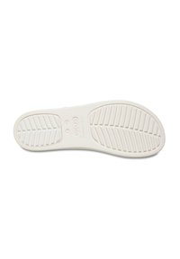 White rubber shoe sole featuring textured tread with grooves for traction, rounded shape, and embossed brand name and size details.