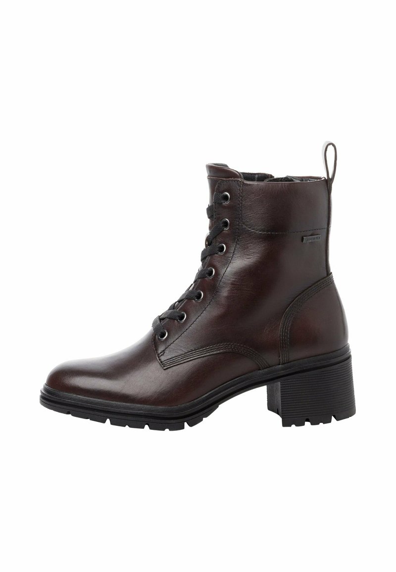 Bottine en cuir marron avec un bout arrondi, fermeture à lacets à l'avant, semelle en caoutchouc noir robuste et talon en bloc bas. Comprend une languette à l'arrière.