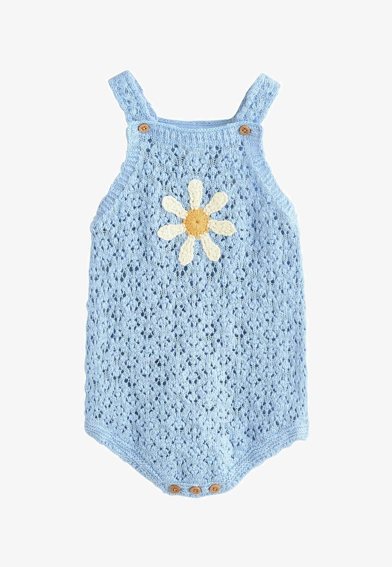 Svetlomodrý pletený detský overal s ramennými popruhmi, drevenými gombíkmi a stredovým vzorom bielej a žltej margarétky.