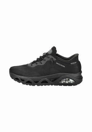 Black Skechers slip-on athletic shoe with mesh upper, air-cushion sole, and lace detail on a white background.