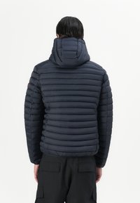 Navy puffer jacket with horizontal quilting, a raised collar, and a detachable hood. Textured fabric with a smooth finish.