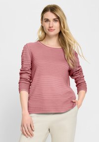 Helles rosa Sweatshirt mit strukturiertem, wellenförmigem Muster. Rundhalsausschnitt und lange Ärmel, mit gerippten Akzenten an den Bündchen und am Saum.