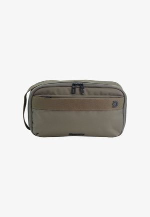Compact olive green travel pouch with dual zipper on top, a front strap, side handle, and small brand logo on front.