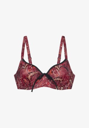 Sarkans un melns rakstains krūšturis ar ziedu motīvu, regulējamām siksnām un loku detaļu centrā. Izgatavots no mīksta auduma.