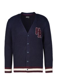 Marinblå stickad cardigan med V-hals, blå knappar, ribbat tyg samt kontrasterande vinröda och vita randiga muddar och nederkant. Emblem på bröstet.