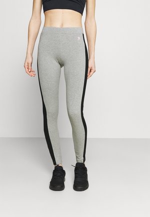Leggings grigi con strisce laterali nere, realizzati in un morbido tessuto misto cotone, con una vita alta e un piccolo logo sull'anca.