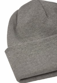 Gray knit beanie hat featuring a ribbed texture, with a folded cuff and a rounded top, designed for warmth and comfort.