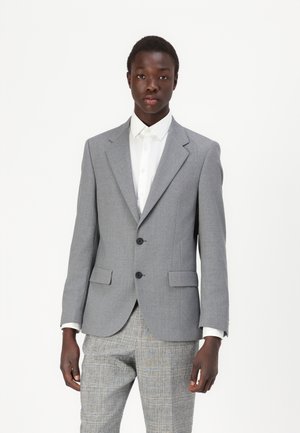 Gray tailored blazer with notched lapels, two black buttons, side pockets, and a smooth fabric finish, paired with a white shirt.