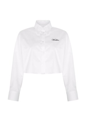 White cropped long-sleeve shirt with button closure, pointed collar, and embroidered logo on the left chest. Smooth cotton fabric.