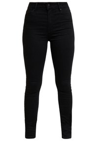 Vaqueros skinny negros hechos de denim elástico. Presenta una cintura alta, diseño de cinco bolsillos y un acabado limpio con una textura suave.