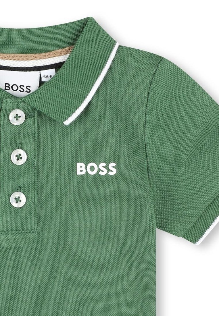 Polo vert en tissu texturé, avec un col blanc, une fermeture à boutons et le logo "BOSS" en blanc sur l'avant.