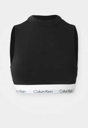 Black cropped tank top with a high neckline. Made of smooth fabric with an elastic white band featuring "Calvin Klein" logo at the hem.