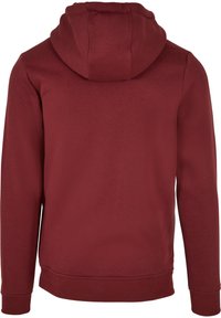 Sweat à capuche marron foncé vu de dos avec manches longues et poignets et ourlet côtelés.