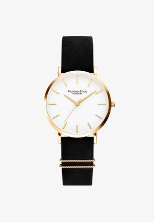 Goldfarbene Uhr mit einem weißen Ziffernblatt, schwarzem strukturiertem Armband, minimalen Stundenmarkierungen und gedrehten goldenen Akzentbändern. Der Markenname ist auf dem Ziffernblatt angezeigt.