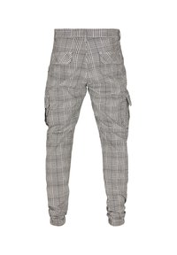Cargo-Hosen mit einem schwarz-weißen Karomuster, ausgestattet mit seitlichen Cargo-Taschen, elastischen Bündchen und einer lässigen Passform. Hergestellt aus einem leichten Stoff.