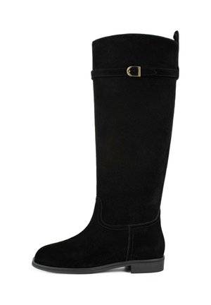 Black suede knee-high boot with a rounded toe, flat heel, and a decorative strap featuring a gold-tone buckle at the top.