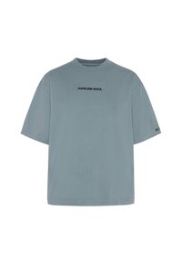 Hellblaues, oversized T-Shirt aus weichem Baumwollstoff. Mit Rundhalsausschnitt und dem Aufdruck "HARLEM SOUL" in Schwarz über der Brust.