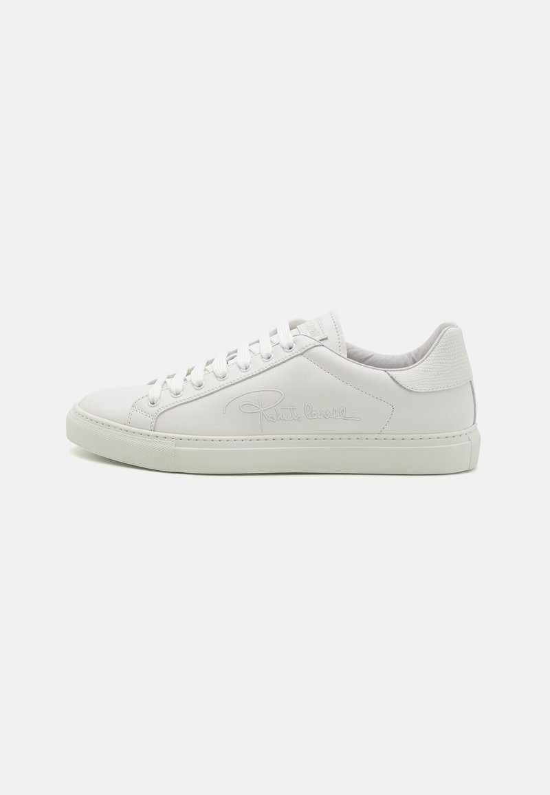 White leather sneakers with a smooth texture, round toe, flat rubber sole, and lace-up design. Features stitched detailing and subtle logo.