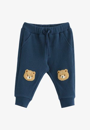 Marineblå teksturerede bukser til småbørn med elastisk talje, snor, sidelommer, ribkant ved anklerne og bamseansigtspatches på knæene.